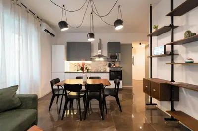 a kitchen and dining room with a table and chairs at Roomeasy Vatican Apartment in Rome