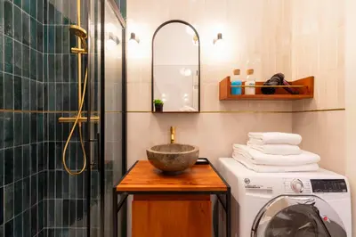 a bathroom with a washing machine and a sink at Roomeasy Vatican Apartment in Rome