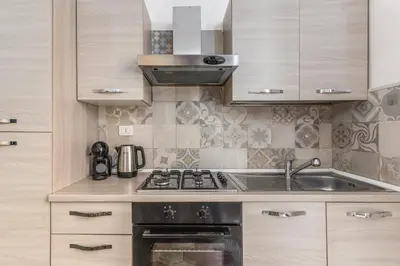 a kitchen with a sink and a stove at Casa Mecenate in Rome