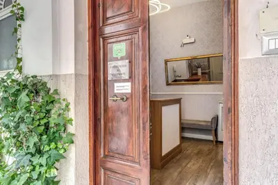 a wooden door leading into a room with a mirror at Casa Mecenate in Rome