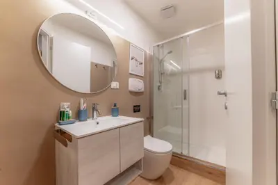 a bathroom with a toilet and a sink and a mirror at Bello Urban Boutique - Golden Keys Collection in Rome