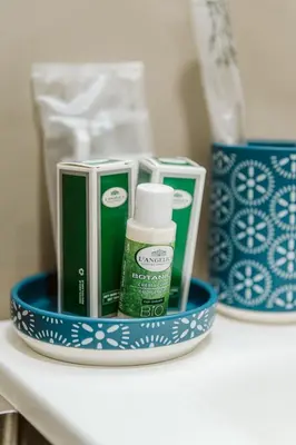 a blue and white holder with toiletries on a shelf at Bello Urban Boutique - Golden Keys Collection in Rome