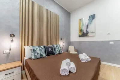 a bedroom with a bed with towels on it at Bello Urban Boutique - Golden Keys Collection in Rome