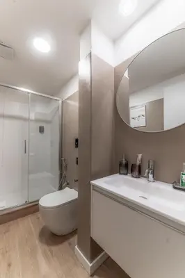 a bathroom with a sink and a toilet and a mirror at Bello Urban Boutique - Golden Keys Collection in Rome