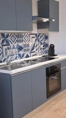 a kitchen with a sink and blue and white tiles at Domus Provinciae in Rome