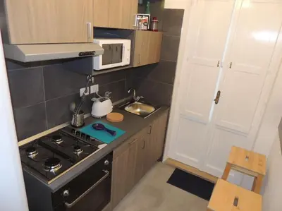 a small kitchen with a stove and a microwave at Apt Central Magenta in Rome