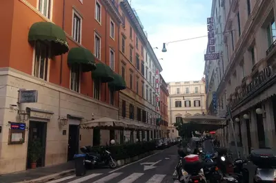 a city street with buildings and motorcycles parked on the street at Apt Central Magenta in Rome