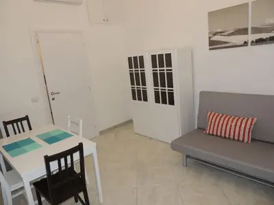 a room with a table and a couch and a table and chair at Apt Central Magenta in Rome