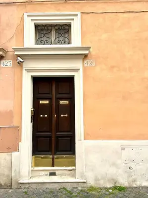 a door with a window above it on a building at Camilla Charme in Rome