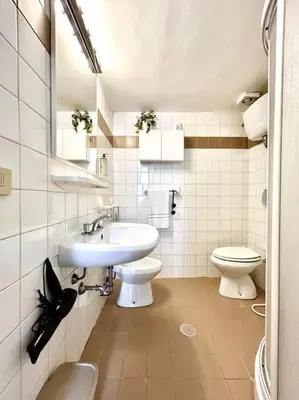 a bathroom with a sink and a toilet at Camilla Charme in Rome