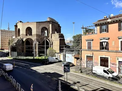 an old building with cars parked in front of it at Camilla Charme in Rome