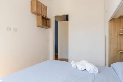 a bedroom with a blue bed with towels on it at Metro San Paolo -Capitol Haus Roma- Cozy Apartment in Rome
