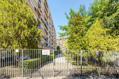 a fence in front of a building with trees at Metro San Paolo -Capitol Haus Roma- Cozy Apartment in Rome