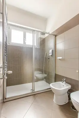 a bathroom with a shower and a toilet and a sink at Metro San Paolo -Capitol Haus Roma- Cozy Apartment in Rome