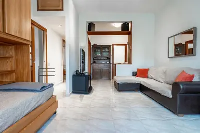 a living room with a bed and a couch at Roma Monteverde Apartment in Rome