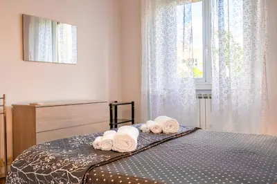 a bedroom with a bed with towels on it at Roma Monteverde Apartment in Rome
