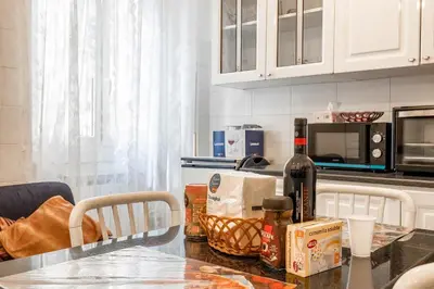 a kitchen with a table with a bottle of wine at Roma Monteverde Apartment in Rome