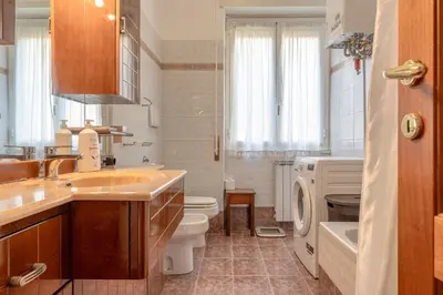 a bathroom with a sink and a toilet and a tub at Roma Monteverde Apartment in Rome