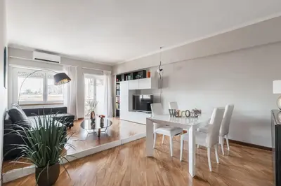 a living room and dining room with a table and chairs at Elegant Hideaway Steps from St Peter in Rome