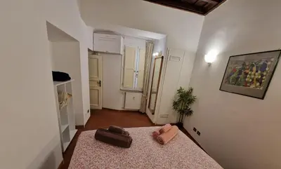 a room with a bed with a suitcase on it at Simple life in Rome in Rome