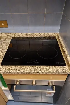 a kitchen counter with a black stove top oven at Simple life in Rome in Rome