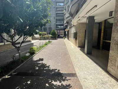 an empty sidewalk next to a building with a tree at Domus Laterani by JFM - Comfortable apartment big terrace Colosseo in Rome