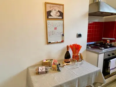 a kitchen with a table with a bottle of wine at Domus Laterani by JFM - Comfortable apartment big terrace Colosseo in Rome