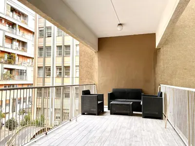 a balcony with chairs and a couch on a building at Domus Laterani by JFM - Comfortable apartment big terrace Colosseo in Rome