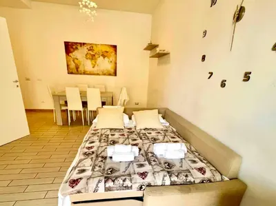 a room with three beds in it with a table and chairs at Domus Laterani by JFM - Comfortable apartment big terrace Colosseo in Rome