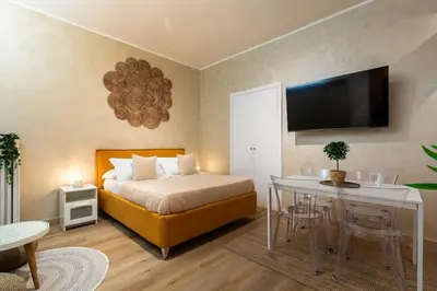 a bedroom with a bed and a table and a television at Domus Romana Musei Vaticani in Rome