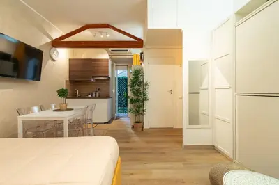 a room with a bed and a table and a kitchen at Domus Romana Musei Vaticani in Rome