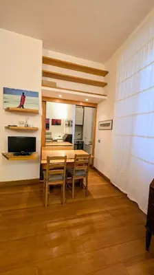 a dining room with a table and chairs in a room at Cozy Home in San Cosimato in Rome