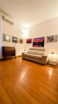 a living room with a couch and a piano at Cozy Home in San Cosimato in Rome