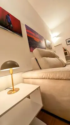 a living room with a couch and a table with a lamp at Cozy Home in San Cosimato in Rome