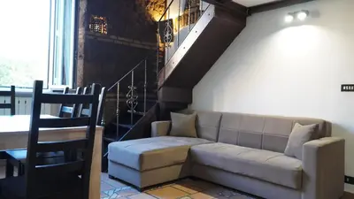 a living room with a couch and a staircase at Al 25 Trastevere, Roma in Rome