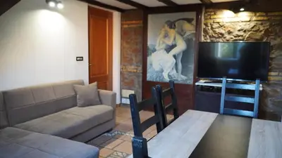 a living room with a couch and a flat screen tv at Al 25 Trastevere, Roma in Rome
