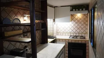 a kitchen with a stove and a counter top at Al 25 Trastevere, Roma in Rome