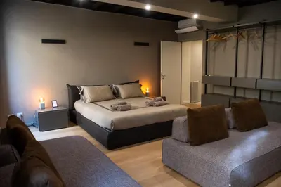 a bedroom with a bed and a couch and chairs at Maison Chic Spagna in Rome