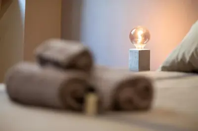 a light bulb sitting on top of a bed at Maison Chic Spagna in Rome