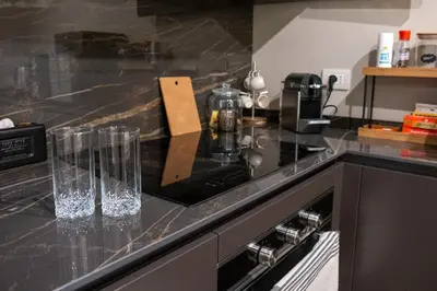 a kitchen counter with two glasses on top of it at Maison Chic Spagna in Rome