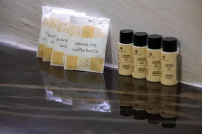 a group of four bottles of hair products on a table at Maison Chic Spagna in Rome