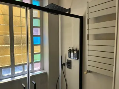 a bathroom with a shower and a glass door at Maison Chic Spagna Two in Rome