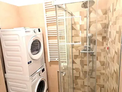 a washing machine in a bathroom with a shower at San Giovanni Metro Flat in Rome