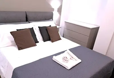 a bedroom with a bed with two towels on it at San Giovanni Metro Flat in Rome