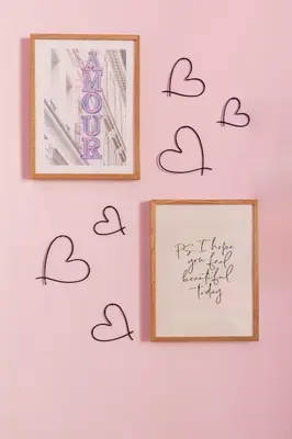 a wall with hearts and a picture on it at Rétro Chic Circo Massimo in Rome