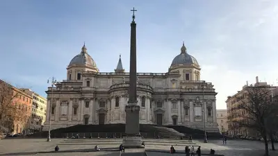 a large building with a pole in front of it at Cozy apartment in Esquilino in Rome