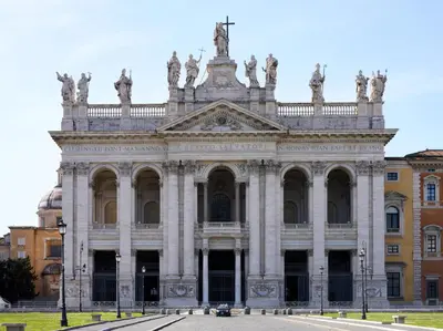 a large building with statues on top of it at Cozy apartment in Esquilino in Rome