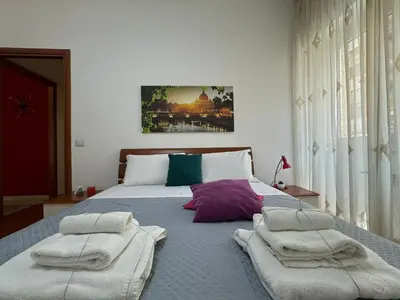 a bedroom with a large bed with towels on it at Hidden Gem in Magliana in Rome