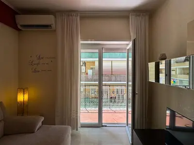 a living room with a sliding glass door to a patio at Hidden Gem in Magliana in Rome