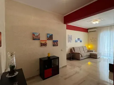 a living room with a couch and a television at Hidden Gem in Magliana in Rome